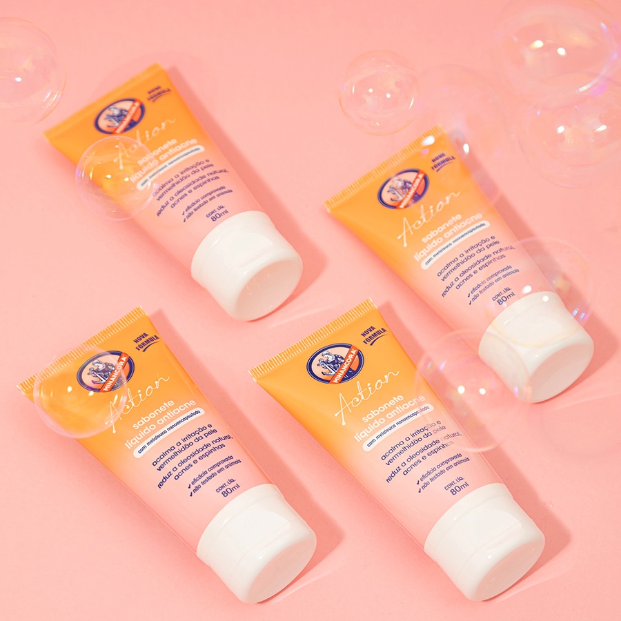 4 Embalagens do Sabonete Líquido Antiacne Minancora em frente a um fundo rosa com bolhas de sabão.